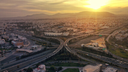 Wall Mural - Aerial drone photo of modern Attiki Odos toll multilevel interchange highway with National road in Attica area at sunset, Athens, Greece