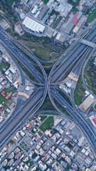 Wall Mural - Aerial drone multilevel junction overpass highway with National toll road at rush hour with moderate traffic
