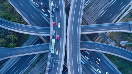 Wall Mural - Aerial drone top down photo of modern Attiki Odos toll multilevel interchange highway with National road in Attica area at sunset, Athens, Greece