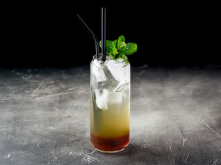 Wall Mural - Cold alcoholic or non-alcoholic cocktail with ice on dark background