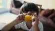 © Marco - Child eating CORN at home. One little boy snacking nutritious FOOD. Child biting a starchy vegetable
