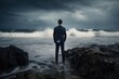 © Peter - Rear view of businessman standing on rock in the ocean facing oncoming waves, created with Generative AI
