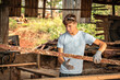 Young man working in a wood yard.