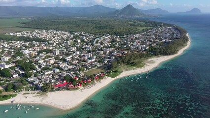 Wall Mural - left panning, aerial Landscape video view of Flic en Flac area with cityscape of Flic en Flac and Beaches with boats in Water and Mauritius mountain landscape in the background - footage    