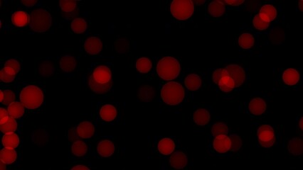 Red Bokeh.  This stock motion video shows the movement of red bokeh against a dark background.