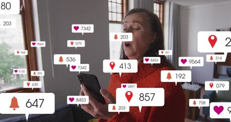 Sticker - Animation of social media icons over caucasian senior woman sneezing while using smartphone at home