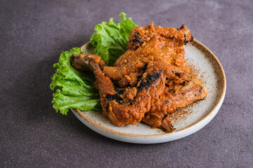 ayam bakar padang or padang grilled chicken from west sumatera. cooked with more spices.
