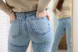 © New Africa - Woman in stylish jeans near mirror indoors, closeup