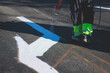 © tsuguliev - Process of making new road surface markings with a line striping machine, workers improve city infrastructure, demarcation marking of pedestrian crossing with a hot melted paint on asphalt pavement