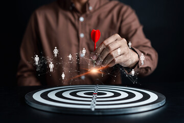 Fototapete - Customer Targeting the business concept, Businessman aiming red arrow dart to the target dartboard, Executive marketing, investment goal and target for planning development customer target group.