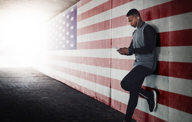 Wall Mural - Music, phone and black man runner relax against an American flag background during training run outdoors. Online, podcast and search by male athlete browse, chill and browse after workout in the USA