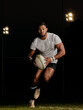 © Delcio/peopleimages.com - Rugby, night and man running with ball to score goal at dark stadium at game, match or practice workout. Sports, fitness and motion, player with action on grass with energy and skill in team sport.