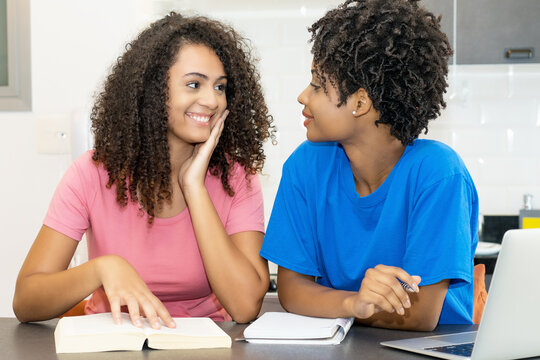 laughing hispanic and african american female student need private lessons for exam
