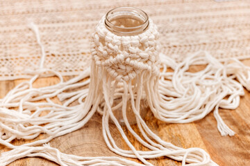 Wall Mural - White macrame. Half work of white macrame on a glass jar.