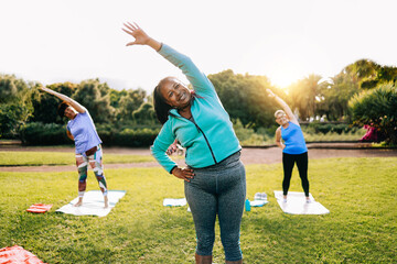 senior sport people exercising during yoga workout class outdoor at park city - fitness joyful elder