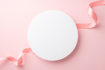 Women's Day concept. Top view photo of white circle and silk ribbon on isolated pastel pink background with copyspace