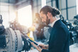 © Quality Stock Arts - Businessman manager in suit working in machinery factory robot assembly plant looking check products inventory for industry products business