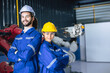 © Quality Stock Arts - Two technician man and woman engineer worker standing smile in robot arm automation assembly plant