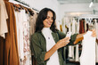 © (JLco) Julia Amaral - Social media marketing for small business: Shop owner taking a picture of a clothing item