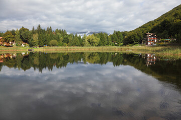 Sticker - Cloudy sky reflected in small lake