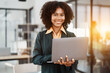 © Jirapong - Beautiful young teen American African holding computer laptop with planning working on financial document, tax, exchange, accounting and Financial advisor