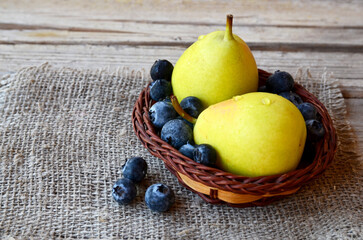 Wall Mural - Fresh ripe pears and blueberries on wooden rustic table. Healthy eating,diet and nutrition concept.
Selective focus.