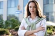 © opolja - Businesswoman portrait. Caucasian female business person standing outdoor looking at camera