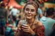Cute beautiful playful flirty hipster girl with a glass of drink hanging out at a summer vacation open air fest concert, flowers, evening light