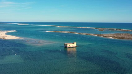 Wall Mural - Aerial view. Drone flight over the natural Portuguese park Ria formosa over village of Fuseta. Rescue house in the middle of a bay