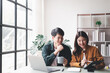 © Tj - young husband and wife working at office by new project and happy.