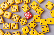 Yellow dice and one red dice on grey background. Object of gambling, poker, and board games. Design