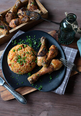 Wall Mural - Djuvec rice with baked chicken drumsticks on a plate