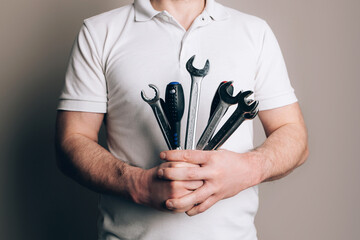 Wall Mural - Man with bouquet of wrenches, spanners and screwdrivers. Father's Day concept