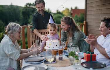 Wall Mural - Multi generation family celebrating birthday and have garden party outside in the backyard on patio.