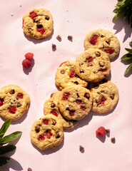 Wall Mural - raspberry and chocolate chip cookies on a pink background