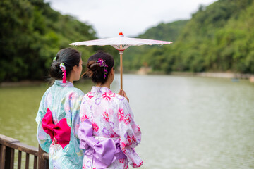 Canvas Print - Friends woman wear Japanese yukata with the lake in countryside