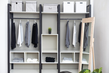 Front view of modern and large wardrobe in dressing room with fashionable woman clothes wear