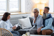 © ArtSys - Senior couple, mature man and woman, husband and wife sitting on the sofa on the therapy session at psychologist cabinet, discussing stress, family problems. Concept of mental health care