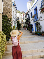 Wall Mural - Tourist in the streets of Santa Cruz neighborhood, Alicante, Valencian Community, Spain. 