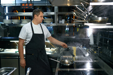 Professional chef cook making vegetarian Italian pasta