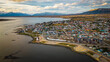 City of Puerto Natales Chile, Aerial Drone Above Town Buildings Amongst Patagonian Landscape of Idyllic Bay Water and Andean Cordillera Background