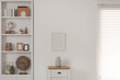 © New Africa - Stylish shelves with different decor elements and chest of drawers in room. Interior design