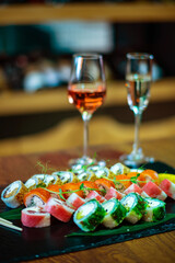 Poster - Sushi roll with salmon and avocado with glass of wine..