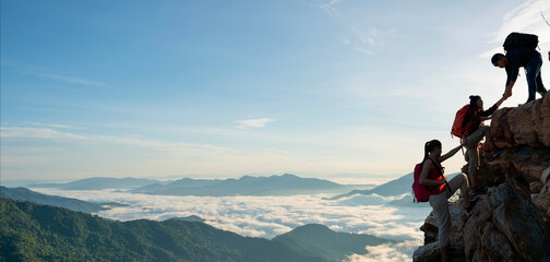 Wall Mural - Asian hiking help each other on mountains