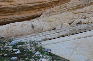 Beautiful rocks and canyons in the wild nature and the dry desert of Wadi Ghweir in Jordan on a bright sunny day