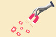 © Aan - businessman hand holding magnet and magnetizing likes symbol. Concept of social media, influence, popularity, modern lifestyle and ad