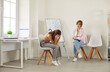 © Studio Romantic - Depression and sorrow. Sad teenage girl is leaning her head in despair while talking at meeting with her psychologist. Woman and child are sitting on chairs in room. Youth problems concept,
