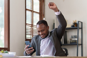 American African black man happy while reading email have a good news in smartphone. business finance and technology concept