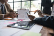 © Natee Meepian - group of business people brainstorm discussing current finance and economy on company investment paperwork at meeting room