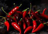 Fototapeta Kuchnia - red chili on a black background, smoke. Generative AI